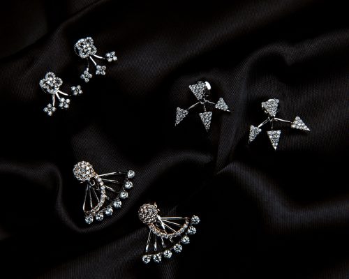 top view of sterling silver earrings with swarovski crystal with studs on black background